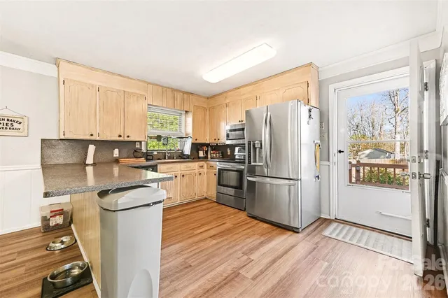 a kitchen with a refrigerator sink and stove