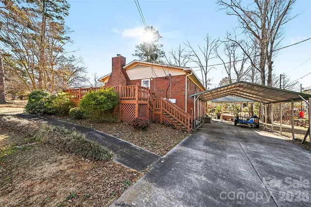 a view of a house with a yard and sitting area