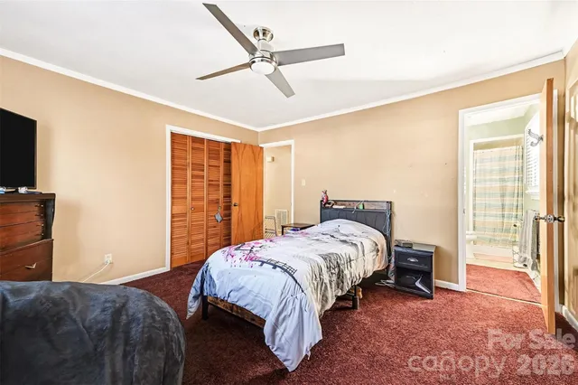 a bedroom with a bed and a television