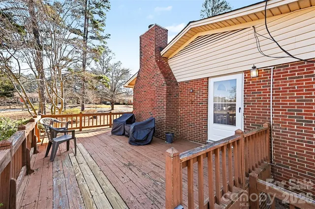a view of balcony with wooden floor and outdoor seating