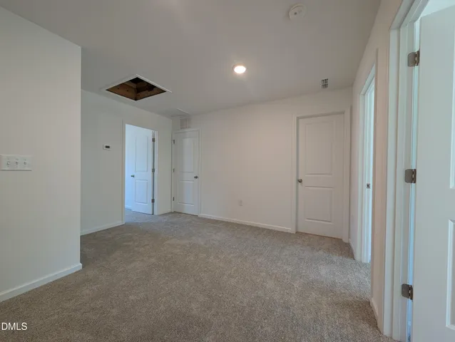 a view of an empty room and a window