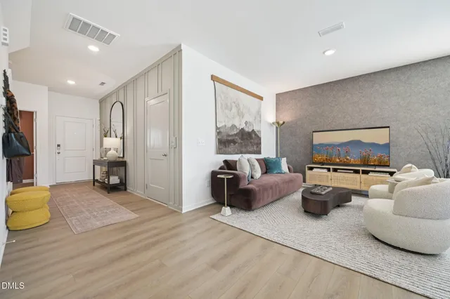 a living room with furniture a rug and a wall painting