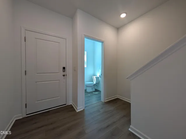 an empty room with wooden floor