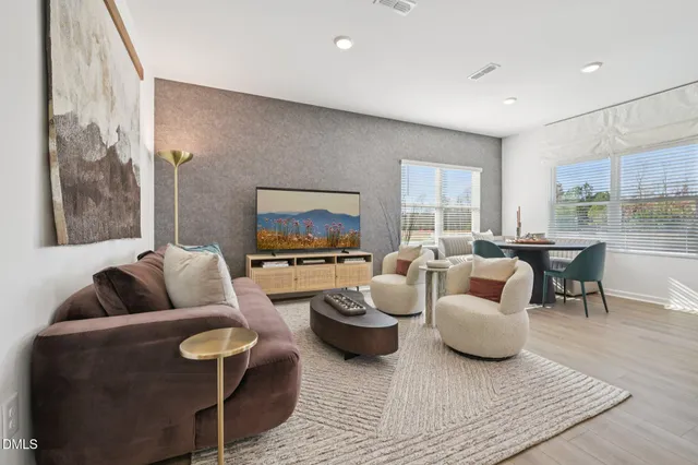 a kitchen with a sink a stove and chairs