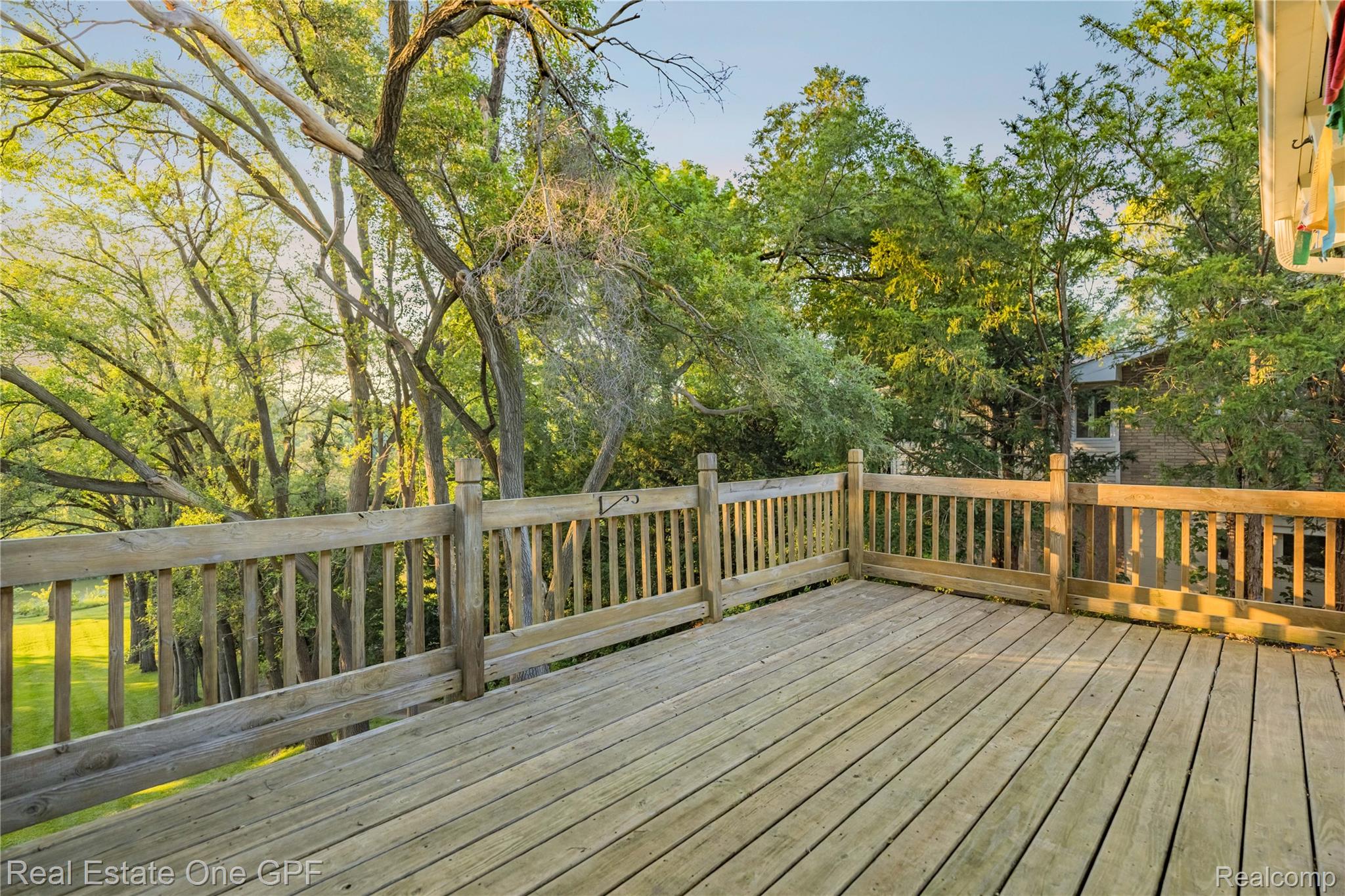 5068 Atkins Road North Street, MI 48049 - Photo 51 of 78 Expansive outdoor deck with natural wood planks and a coordinating wood railing