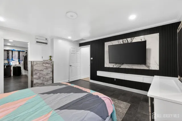 a bedroom with a bed and a flat screen tv