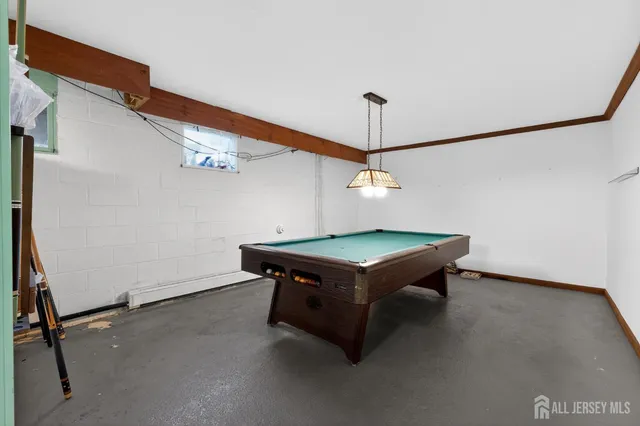 a room with pool table and a chandelier
