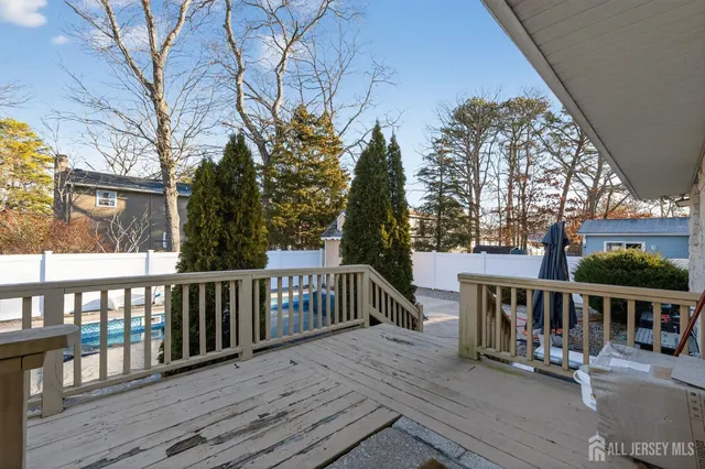 a view of a deck with mountain view and wooden floor