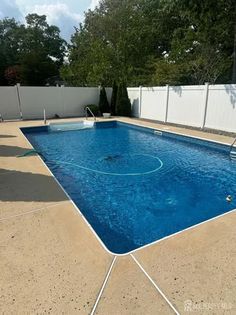 a view of swimming pool with a chair
