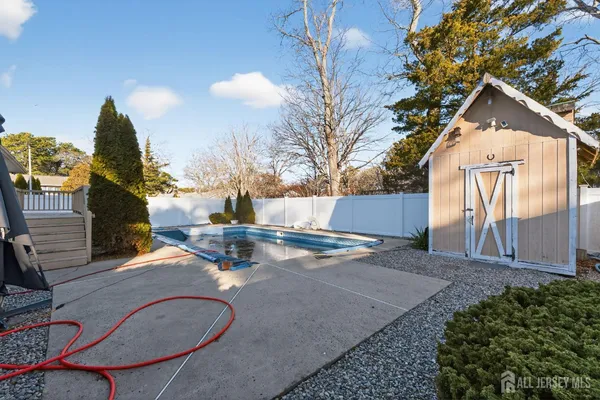 a backyard of a house with table and chairs