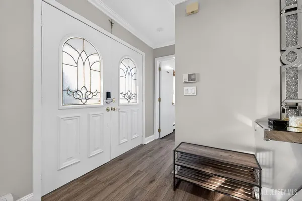 a view of a livingroom with wooden floor and a window