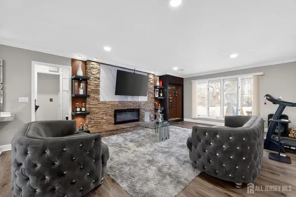 a living room with furniture a flat screen tv and a fireplace