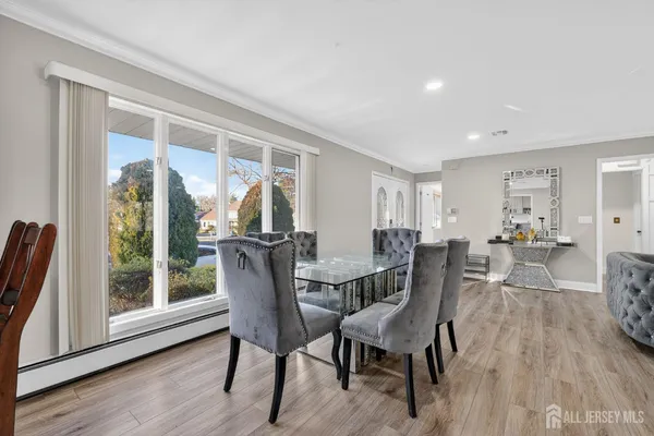 a view of a dining room with furniture and wooden floor