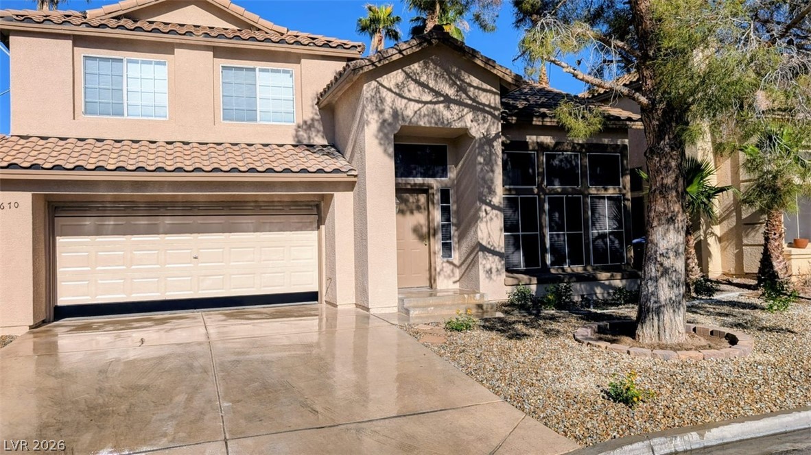 2670 Ridgewater Circle Henderson, NV 89074 - Photo 22 of 22 A terracotta-tiled roof crowns this residence, featuring a two-car garage and xeriscape landscaping.