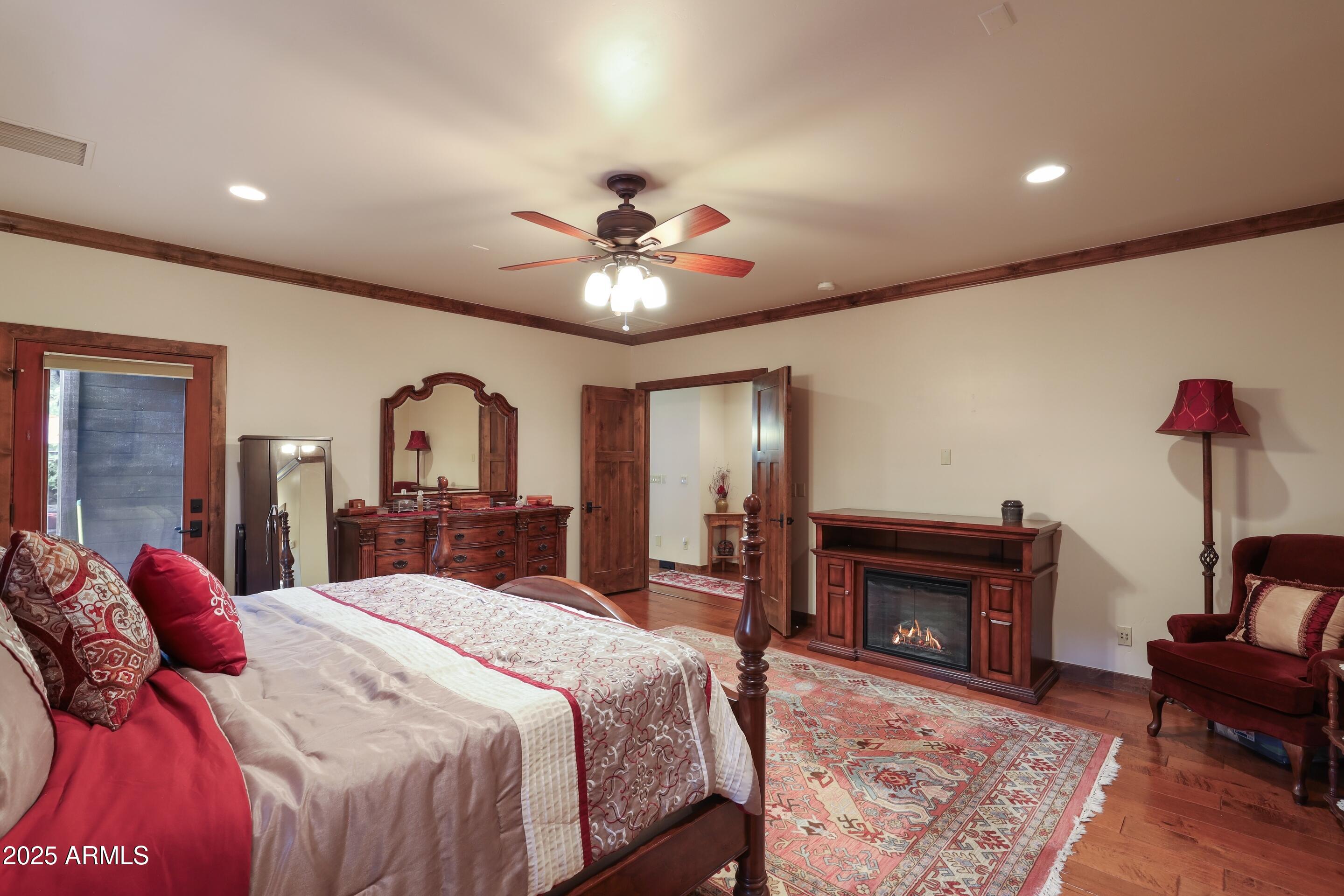 2307 East Grapevine Drive Payson, AZ 85541 - Photo 14 of 40 a bedroom with a bed and a chandelier