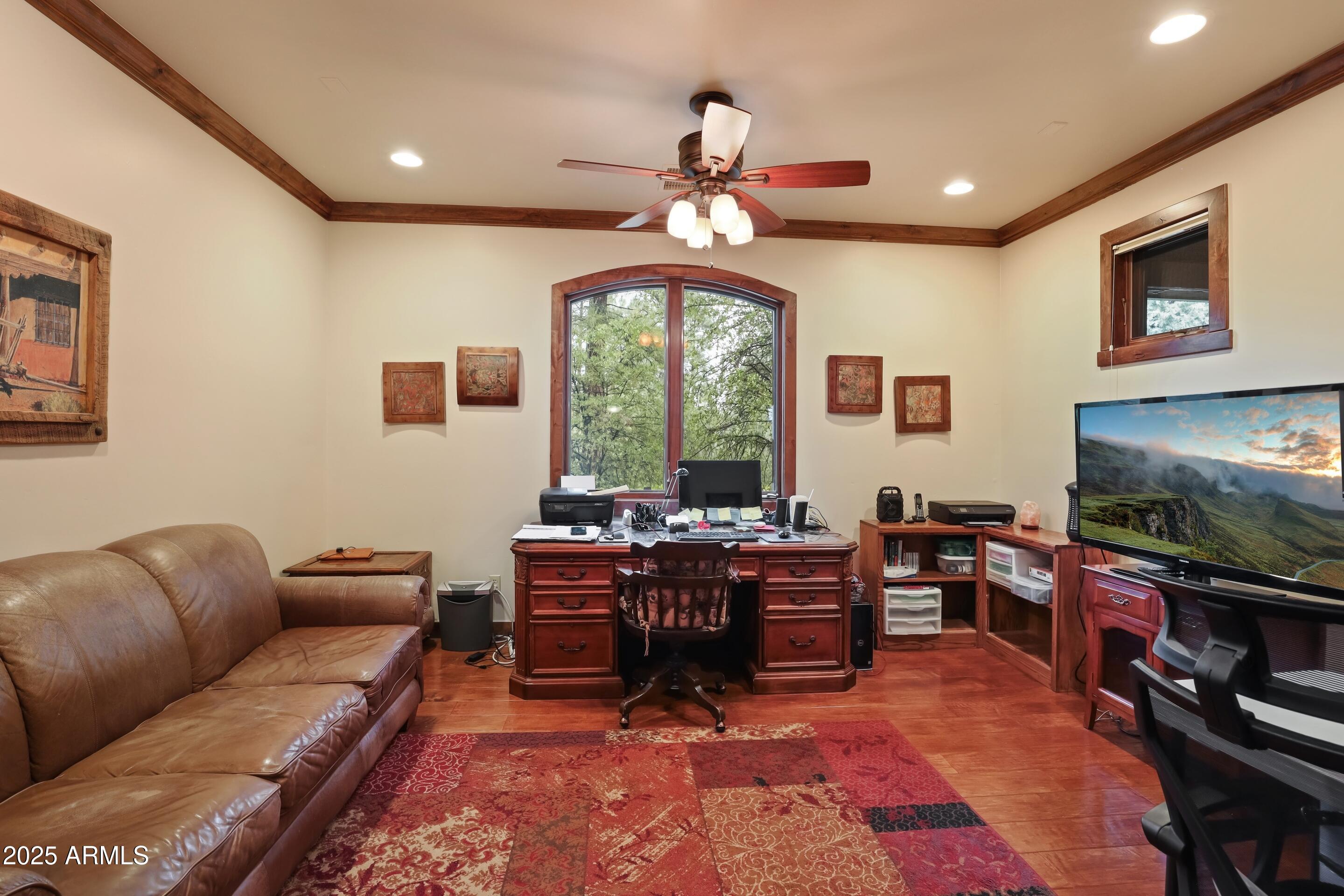 2307 East Grapevine Drive Payson, AZ 85541 - Photo 17 of 40 a living room with furniture a flat screen tv and a large window