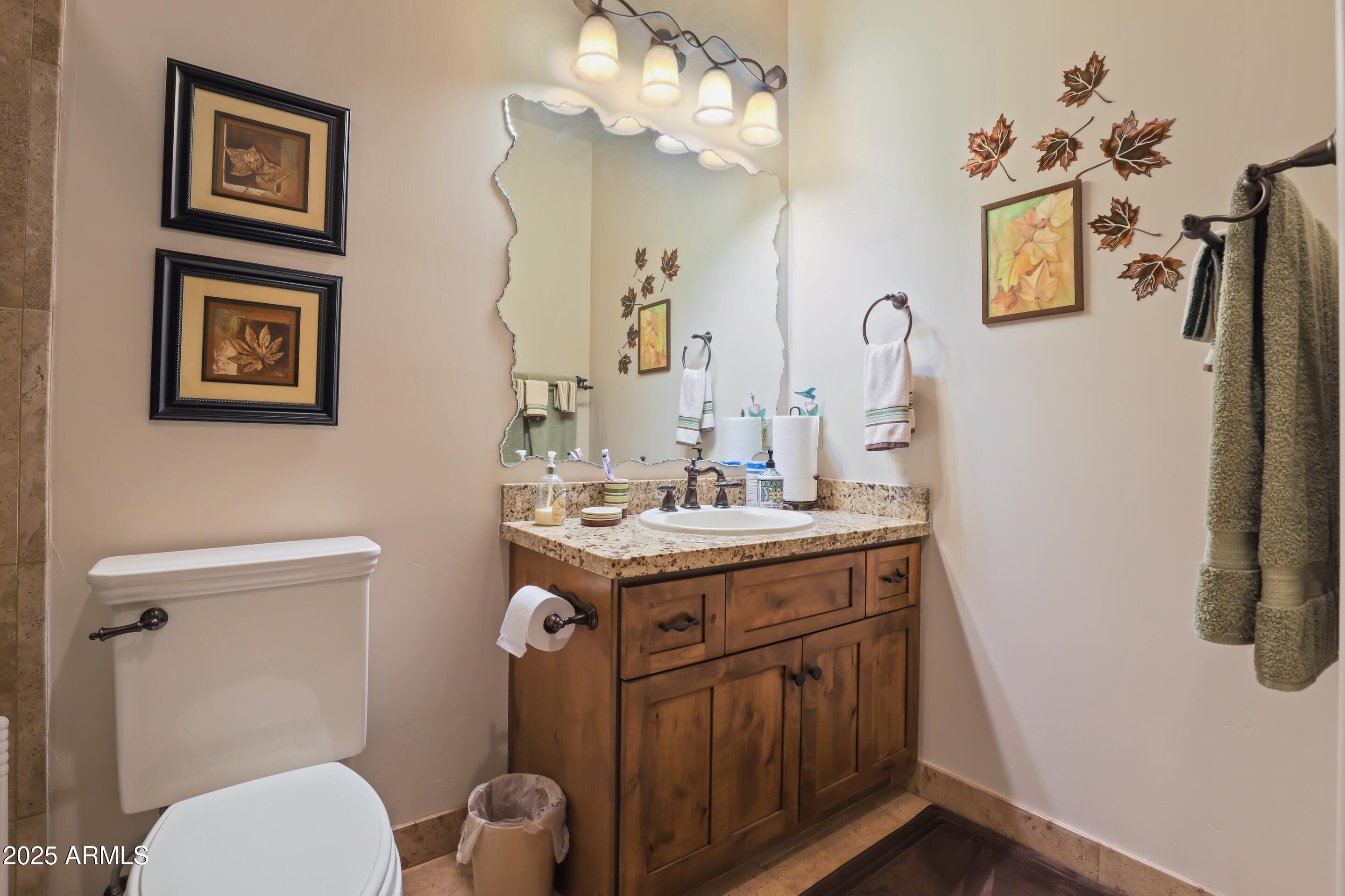 2307 East Grapevine Drive Payson, AZ 85541 - Photo 20 of 40 a bathroom with a granite countertop toilet sink and mirror