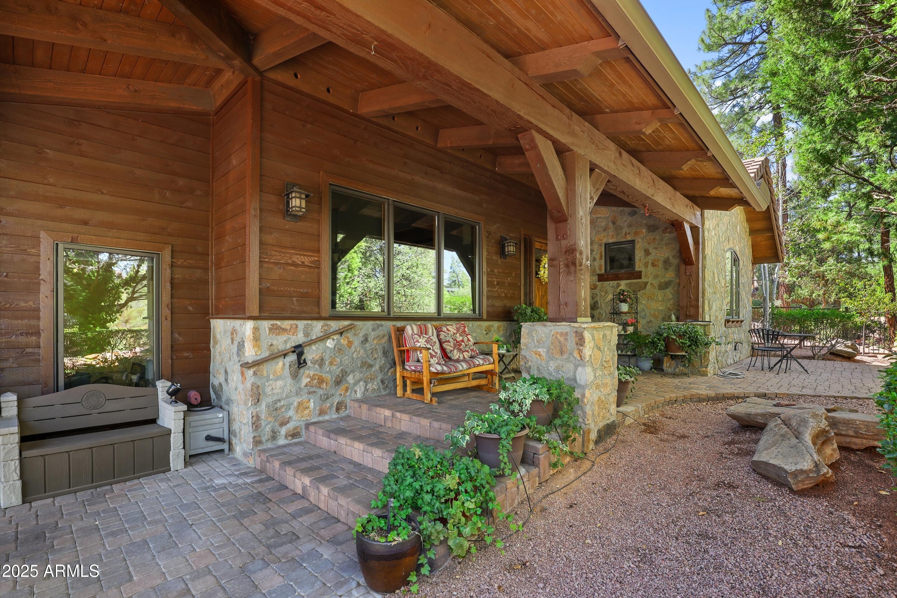 2307 East Grapevine Drive Payson, AZ 85541 - Photo 27 of 40 a view of a patio with table and chairs potted plants with wooden fence