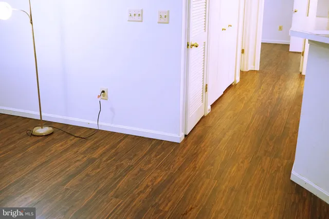 a view of an empty room with closet and a window