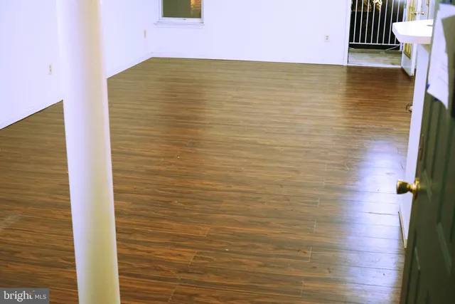 a view of a room with wooden floor and windows
