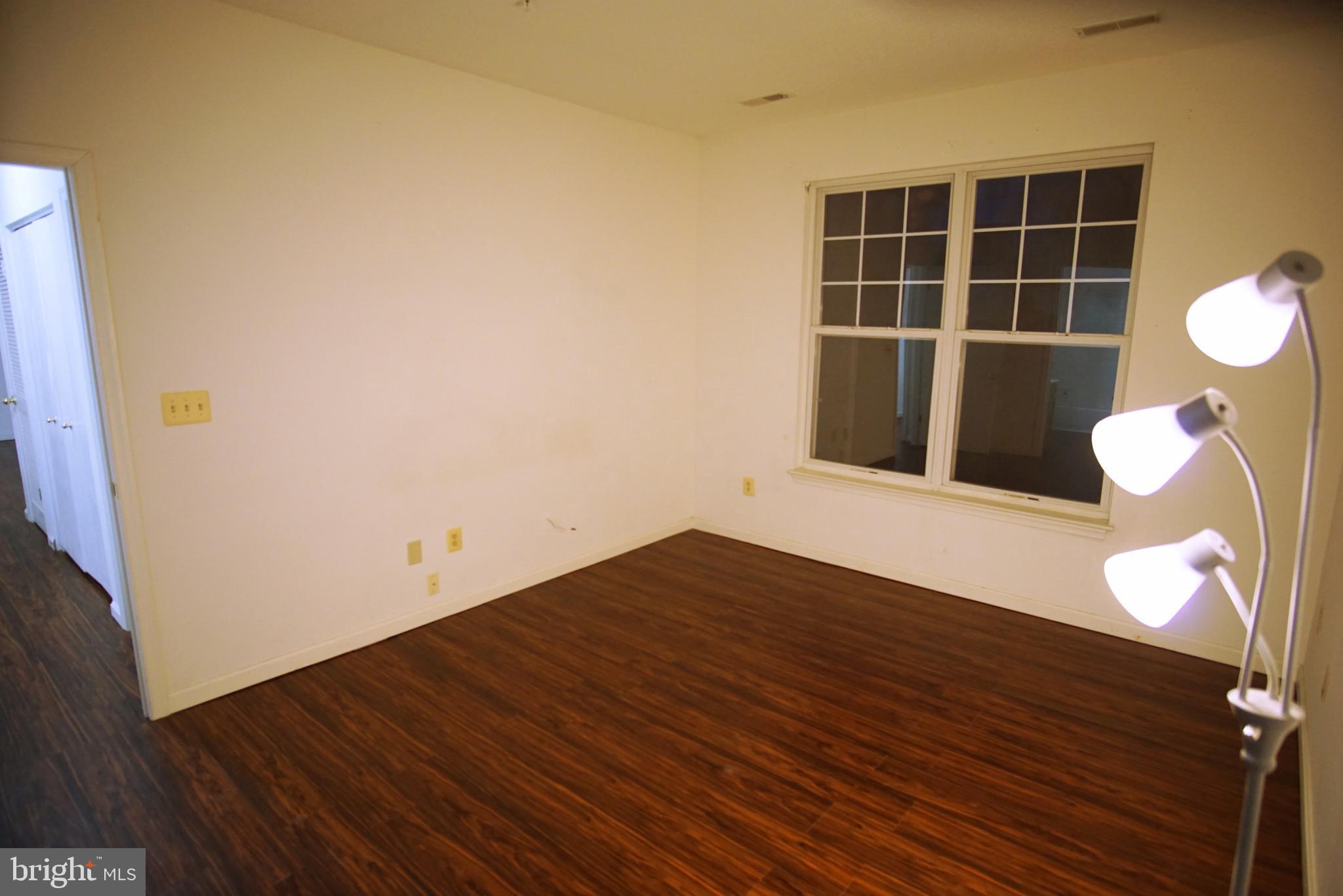 7115 Sandown Circle, Unit 202 Windsor Mill, MD 21244 - Photo 23 of 60 a view of a room with wooden floor and windows