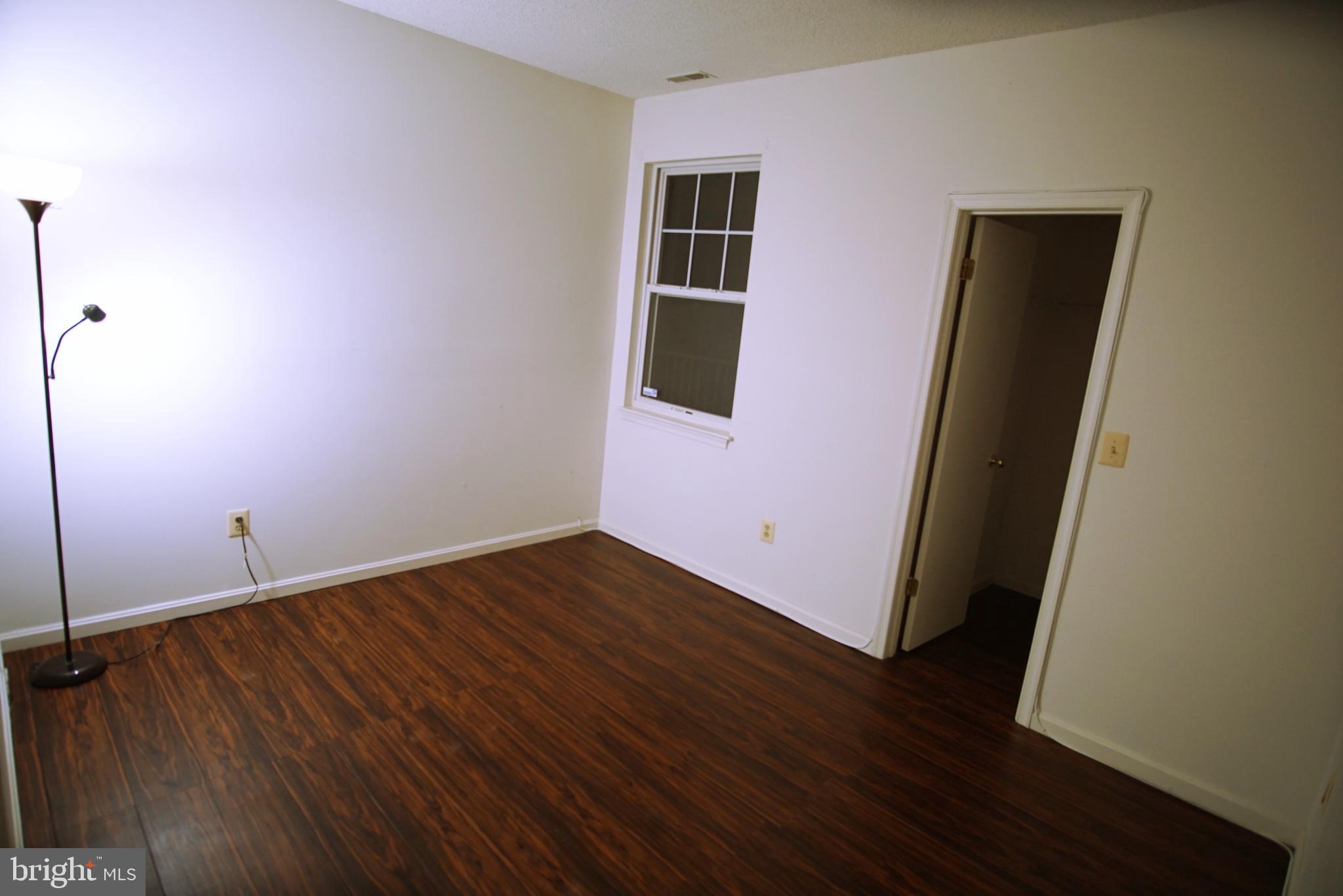 7115 Sandown Circle, Unit 202 Windsor Mill, MD 21244 - Photo 24 of 60 a view of an empty room with wooden floor and closet