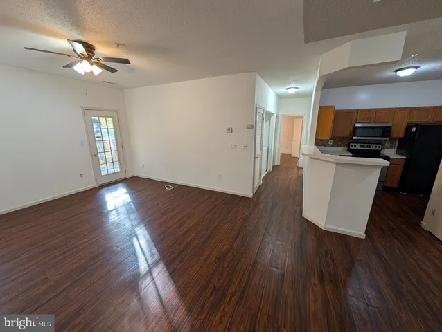 a view of kitchen with sink and wooden floor