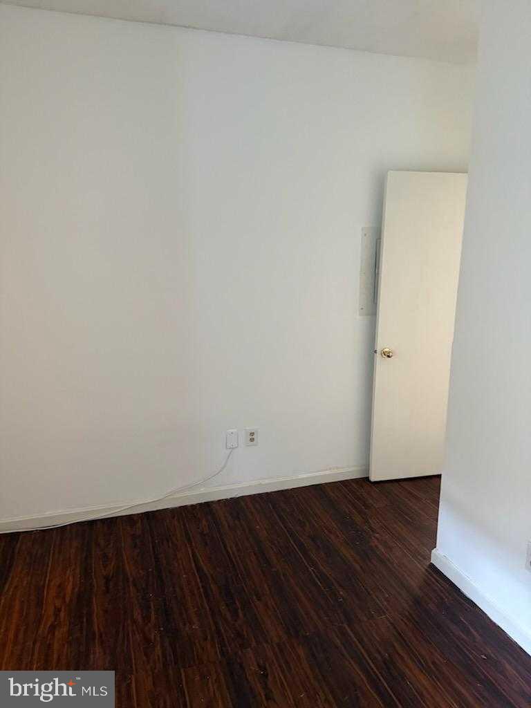 7115 Sandown Circle, Unit 202 Windsor Mill, MD 21244 - Photo 32 of 60 a view of an empty room with wooden floor