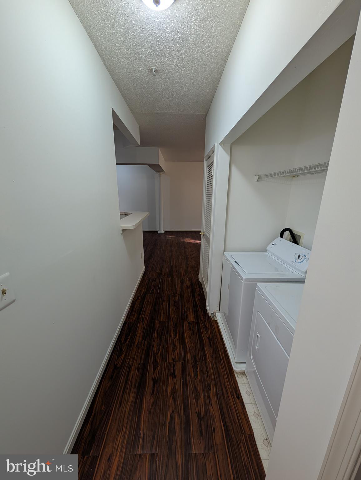 7115 Sandown Circle, Unit 202 Windsor Mill, MD 21244 - Photo 52 of 60 a view of a hallway with wooden floor