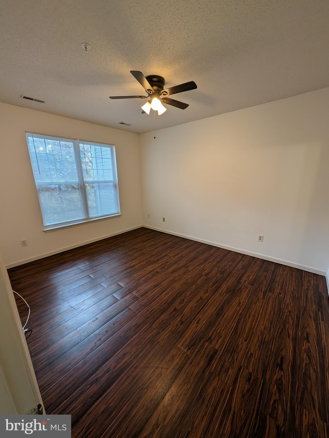 7115 Sandown Circle, Unit 202 Windsor Mill, MD 21244 - Photo 55 of 60 a view of an empty room with wooden floor and a window