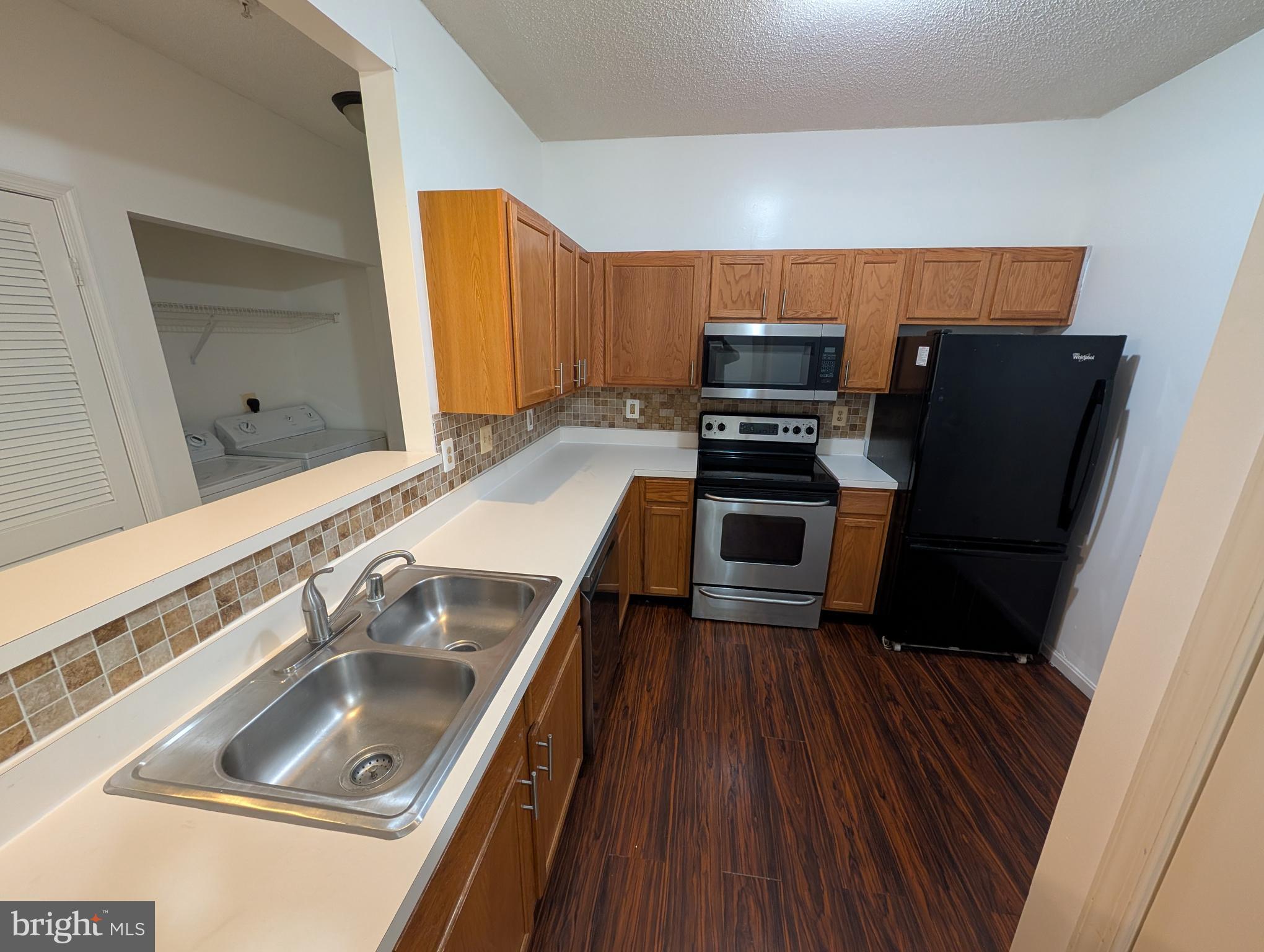 7115 Sandown Circle, Unit 202 Windsor Mill, MD 21244 - Photo 57 of 60 a kitchen with a sink stove and refrigerator