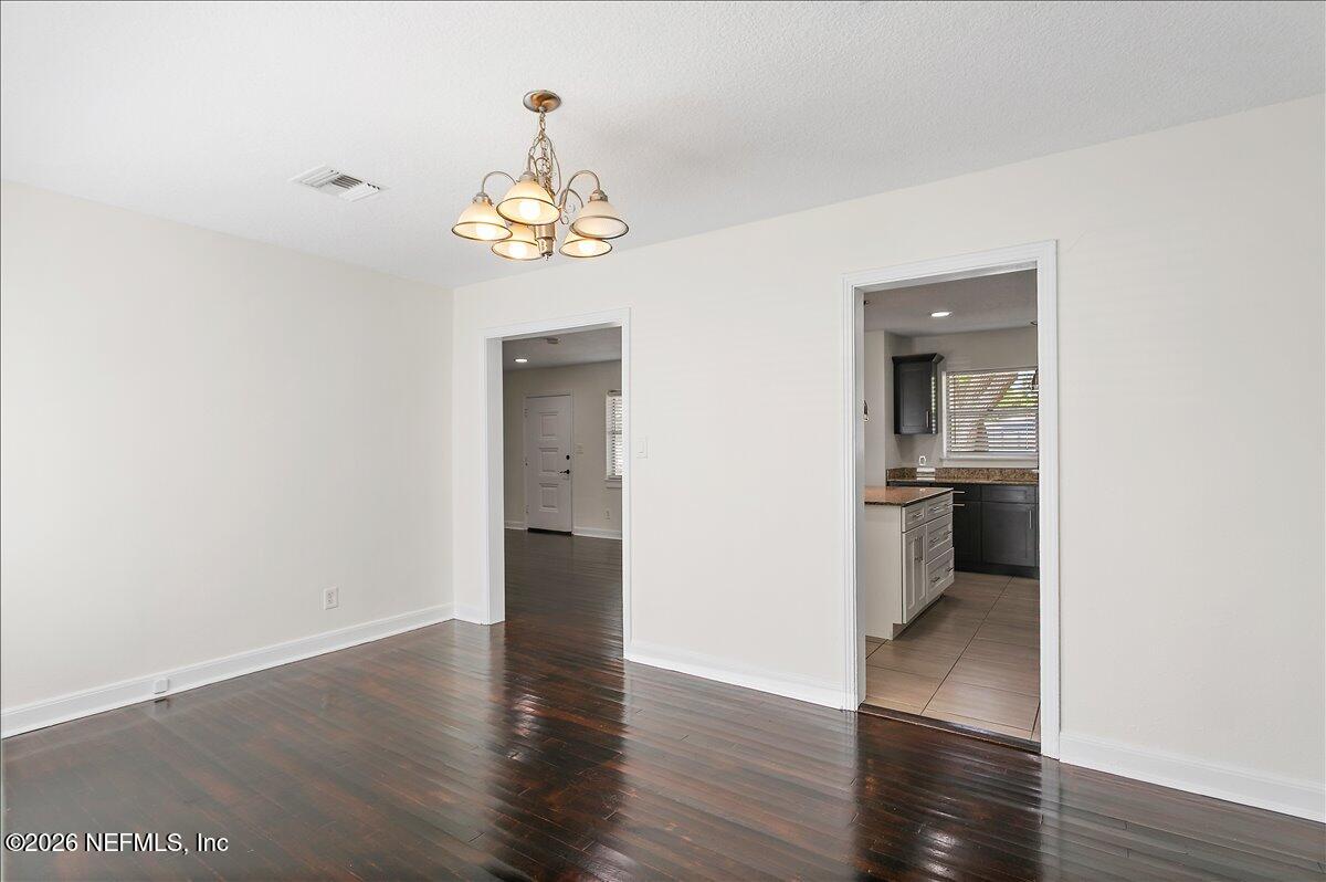103 Coronado Street St. Augustine, FL 32080 - Photo 11 of 25 a view of a kitchen with a dishwasher a kitchen view and wooden floor