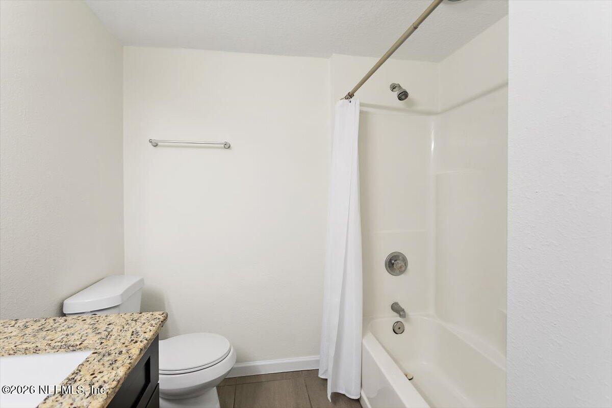 103 Coronado Street St. Augustine, FL 32080 - Photo 15 of 25 a bathroom with a granite countertop bathtub shower sink vanity and toilet