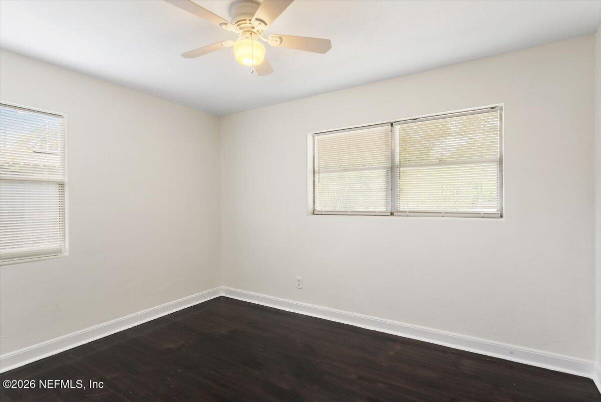 103 Coronado Street St. Augustine, FL 32080 - Photo 16 of 25 an empty room with wooden floor and windows