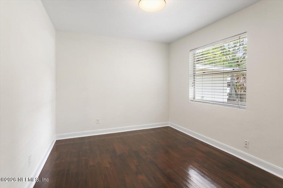 103 Coronado Street St. Augustine, FL 32080 - Photo 19 of 25 an empty room with wooden floor and windows