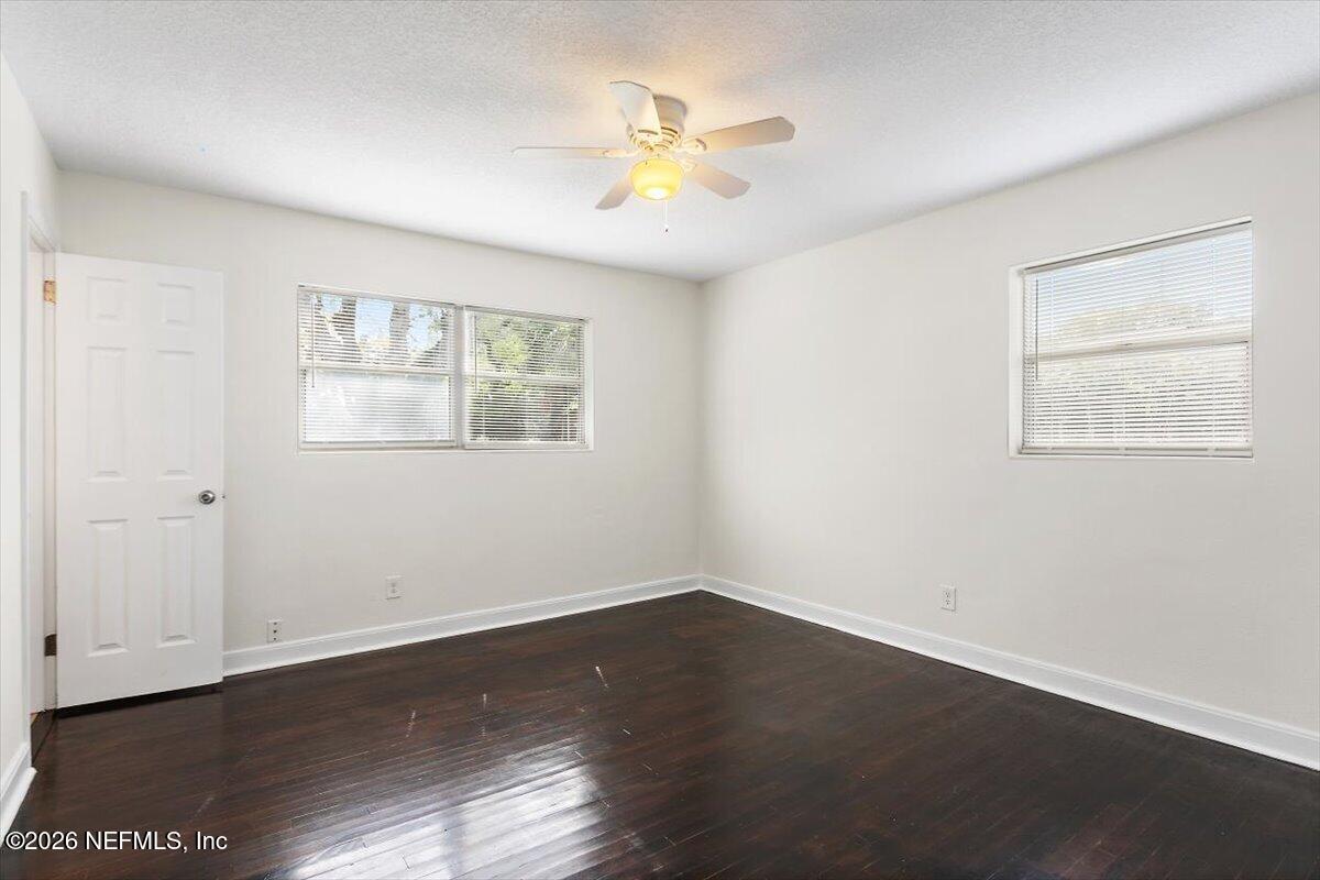 103 Coronado Street St. Augustine, FL 32080 - Photo 20 of 25 a view of an empty room with wooden floor and a window
