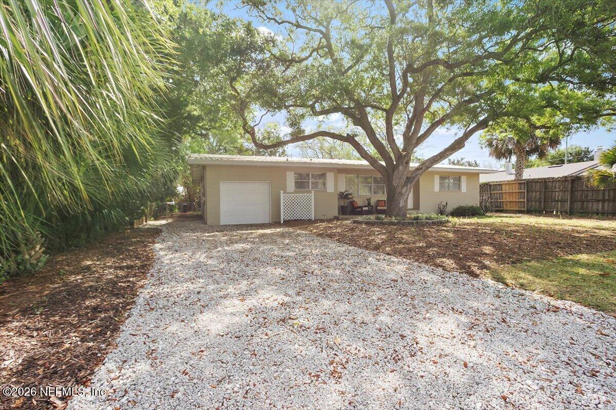 103 Coronado Street St. Augustine, FL 32080 - Photo 2 of 25 a front view of a house with a garden