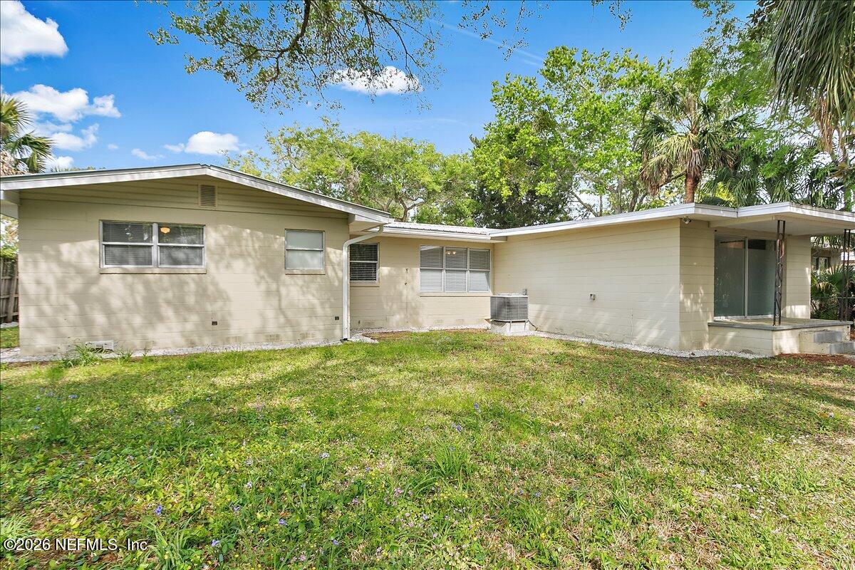 103 Coronado Street St. Augustine, FL 32080 - Photo 23 of 25 a backyard of a house with plants and large tree