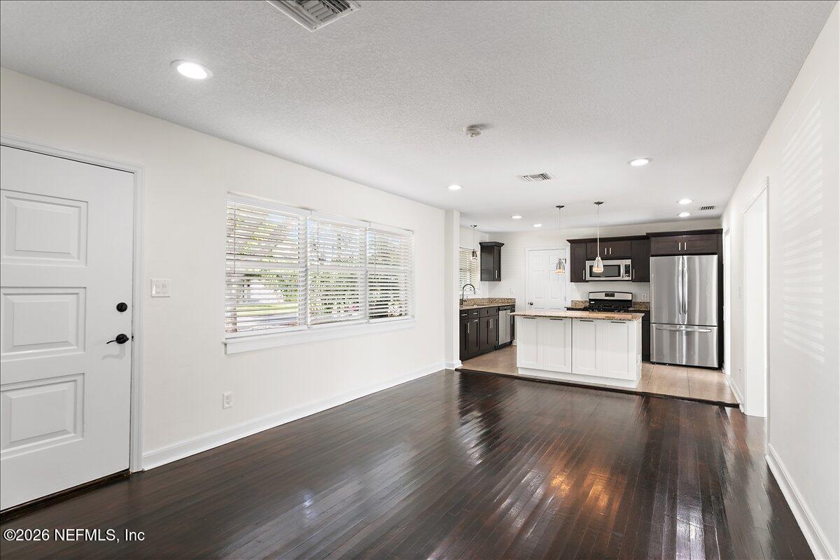103 Coronado Street St. Augustine, FL 32080 - Photo 4 of 25 a view of kitchen with granite countertop cabinets and refrigerator