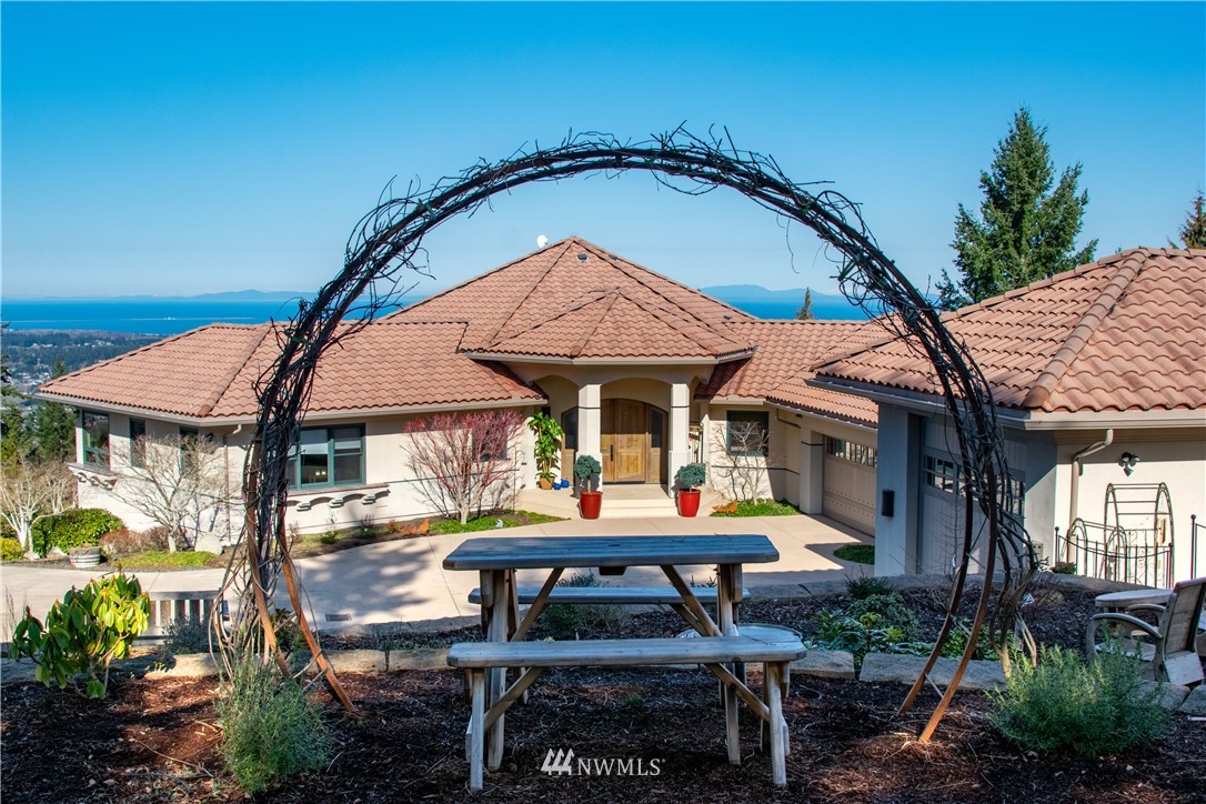 335 Quails Roost Road Sequim, WA 98382 - Photo 40 of 40 a backyard of a house with table and chairs