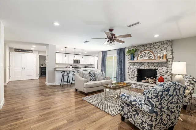 a dining room with furniture a chandelier and wooden floor