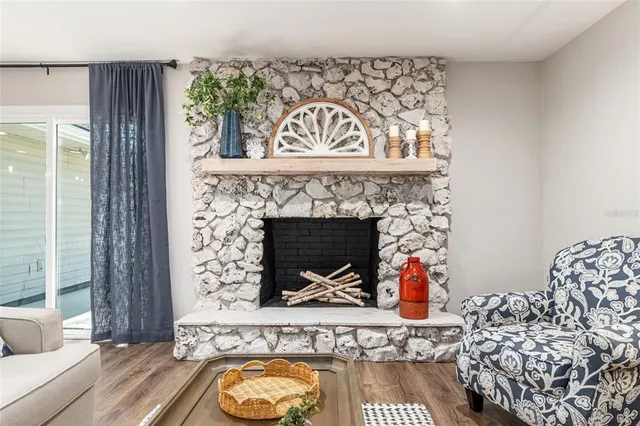 a view of a dining room and livingroom with furniture wooden floor a chandelier
