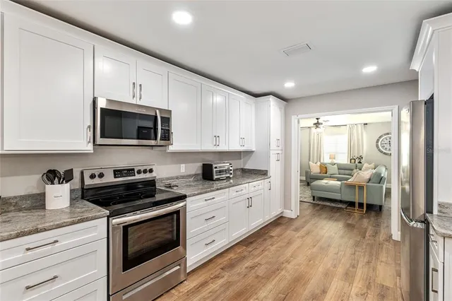 a bedroom with a bed and painting on the wall