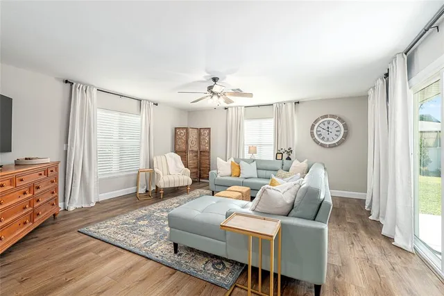 a bathroom with a granite countertop sink a mirror a bathtub and shower