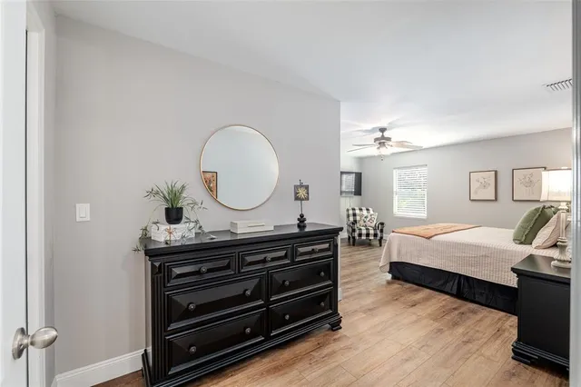 a bedroom with two beds and a chandelier