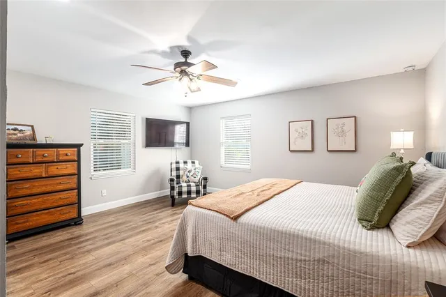 a bedroom with two beds and a chandelier