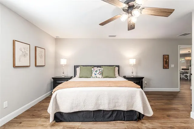 a bedroom with a bed and a chandelier