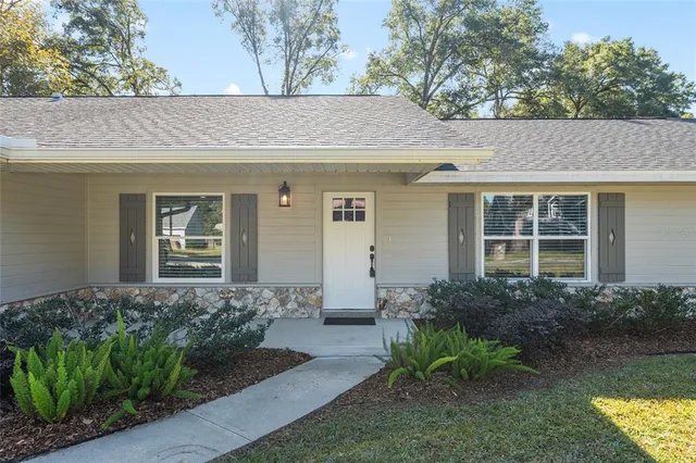 a view of a workspace with wooden floor and furniture