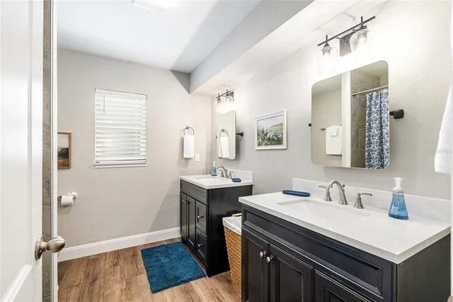 a view of a house with a big yard potted plants and large tree