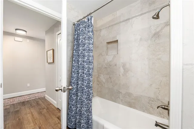 a view of a patio with table and chairs and potted plants with large tree